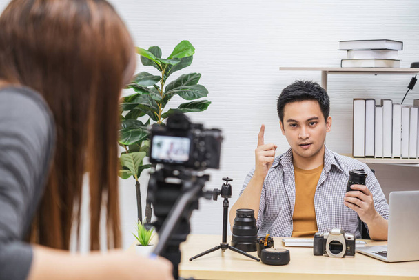 Camera taking video and live with laptop of Asian Vlogger man satisfied the camera lens each media, sharing knowledge to audience via camera by social media channel,vlog and Influencer concept - Fotografie, Obrázek