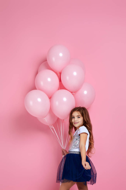 child girl posing with pastel pink air balloons - 写真・画像