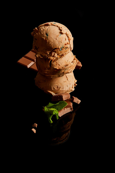 fresh delicious chocolate ice cream with mint leaves isolated on black - Foto, imagen
