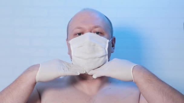 A man in a medical mask plays on the camera. - Footage, Video