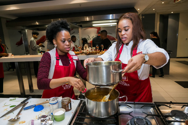 Johannesburg, South Africa - October 05, 2017: Young African women learning to cook and bake at a cooking class - 写真・画像
