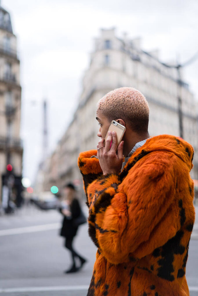 young handsome african american man on the street talking on a smartphone. - 写真・画像