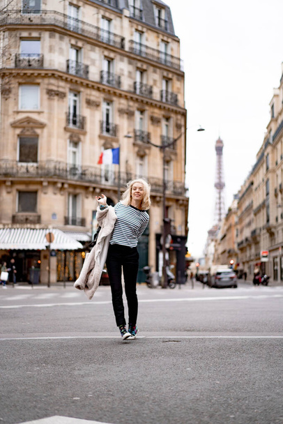 Young beautiful woman outdoors in Paris. Travel concept. Funny photos - 写真・画像