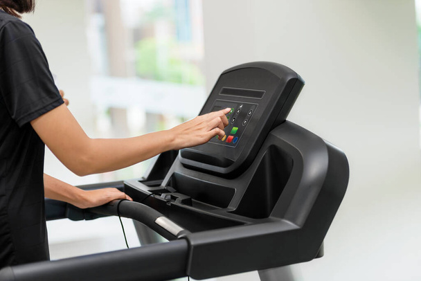 Woman exercising on a treadmill in the gym - Fotó, kép