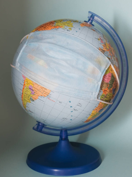 protective medical mask on a globe close-up - Photo, Image