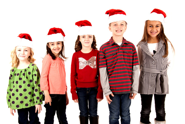 five kids standing wearing santa hats smiling - 写真・画像