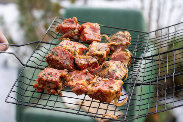 Raw marinaded juicy pork meat in grill grates - Photo, Image