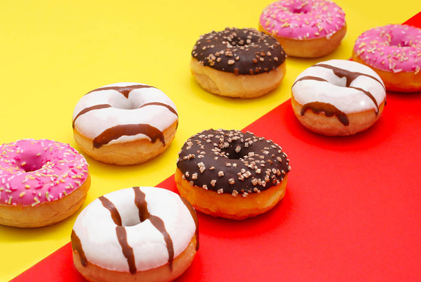 oito donuts em um fundo amarelo-vermelho-rosa
 - Foto, Imagem