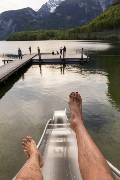 pieds d'un homme sautant sur une glissière dans le lac
 - Photo, image