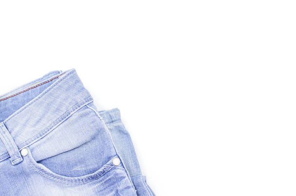 Blue jeans is on a white background. Clothes for donations. Fragments of clothing. - Fotoğraf, Görsel