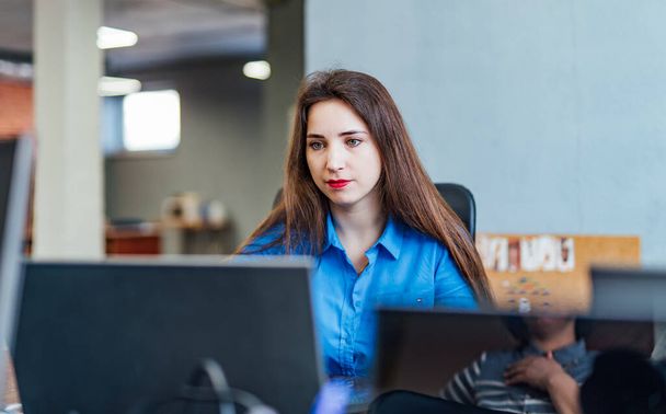 Startup business. Software developer working on computer at modern office. Female at work. - Foto, imagen
