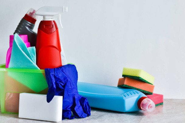 Bottles of detergents and cleaning products on a white background. Rags, sponges, gloves, bottles with space for text. - Photo, Image