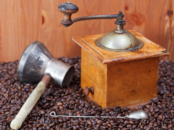 coffee grinder and copper pot on roasted beans - Photo, Image