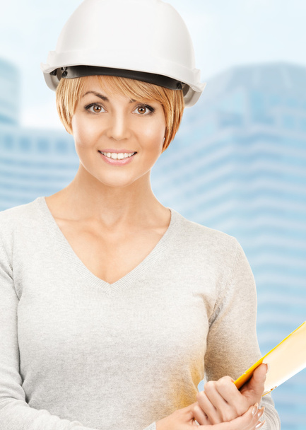 Female contractor in helmet with bluepring - 写真・画像