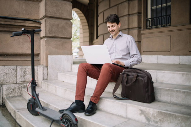 Young male freelancer working on laptop outdoor - Valokuva, kuva