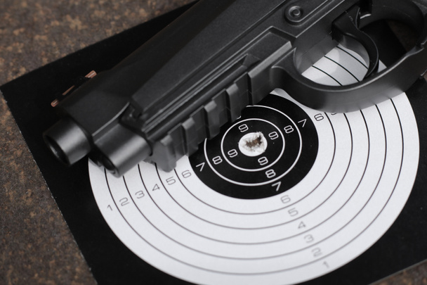Black pistol and target close up - Photo, Image