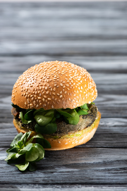 tasty vegan burger with microgreens served on wooden table - Photo, Image