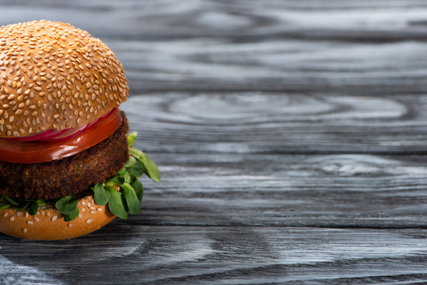 tasty vegan burger with vegetables served on wooden table - Photo, Image