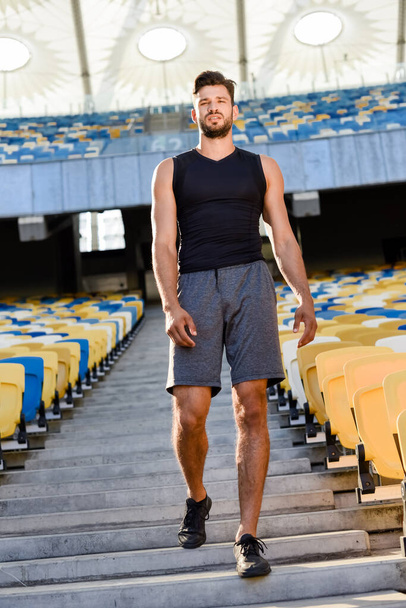 young sportsman walking on stairs at stadium - Zdjęcie, obraz