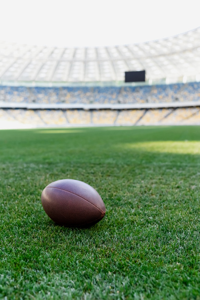 rugby ball on green grass at stadium with copy space - Fotoğraf, Görsel