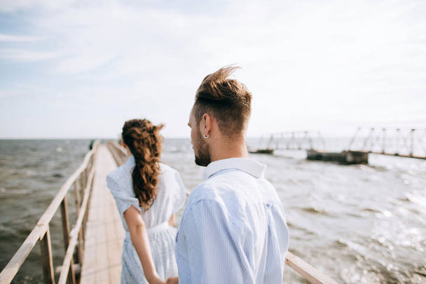 Young couple walking on the sea pier. Summer vacation - Fotoğraf, Görsel