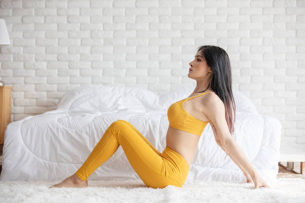 Happy Athletic Asian woman practice yoga stretching pose for stretching muscle for warm up with meditation smile after wake up in the morning Feeling so comfortable and relax,Healthcare Concept - Zdjęcie, obraz