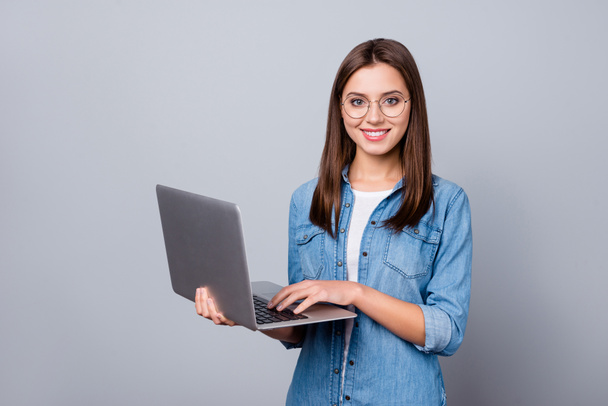 Portrait of positive cheerful clever intelligent ceo expert girl work laptop ready decide work solution wear stylish denim clothes isolated over gray color background - 写真・画像