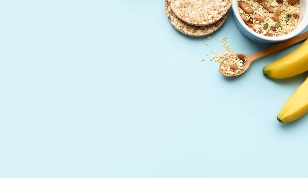Useful breakfast, proper nutrition, oatmeal, dried fruits, breads, fruits, a centimeter on a light background. Diet. A place for text. Flat lay - Фото, изображение