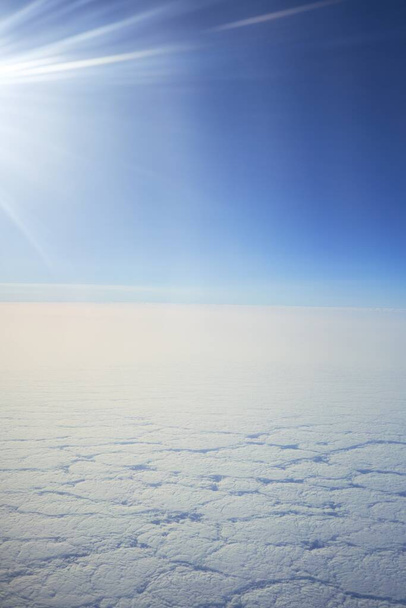Cloudscape from window airplane, landscape of wing plane on a cloudy sky - 写真・画像