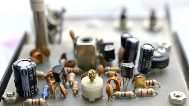 Dusty and dirty vintage electronics background with resisters, capacitors,diodes and other components. - Photo, Image