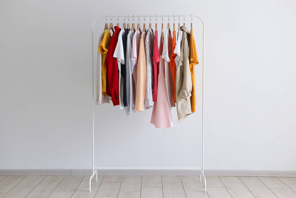 fashion clothes on a stand in a light background indoors. place for text - Fotoğraf, Görsel