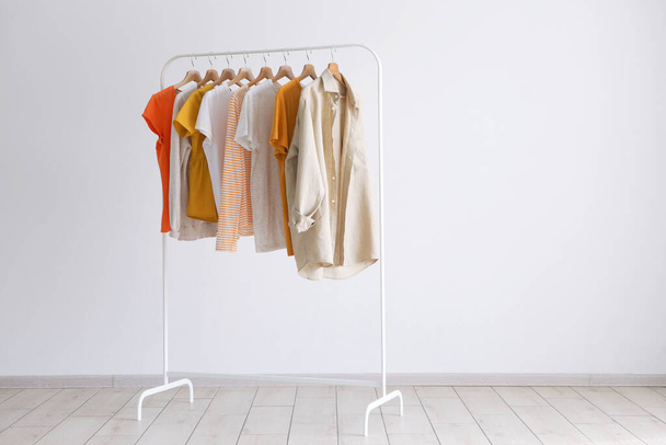 fashion clothes on a stand in a light background indoors. place for text - Fotografie, Obrázek
