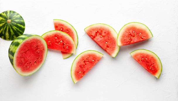 Slices of fresh watermelon on white background. Summer concept of healthy food. Flat lay, copy space. - Foto, Imagem