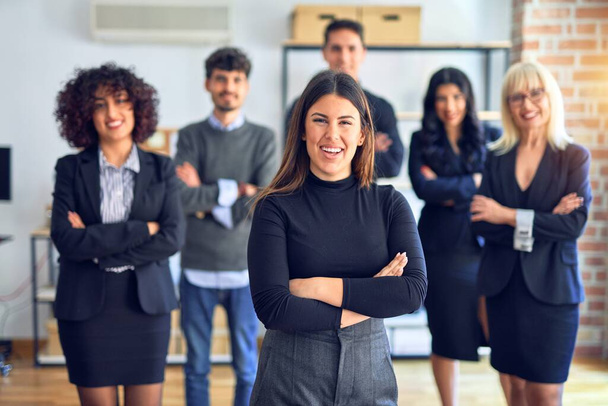 Group of business workers smiling happy and confident. Posing together with smile on face looking at the camera, young beautiful woman with crossed arms at the office - Photo, Image