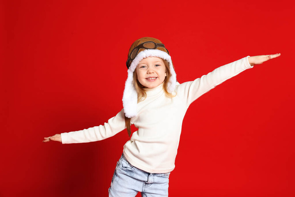 Portrait of cute little girl on red background - Foto, Imagen