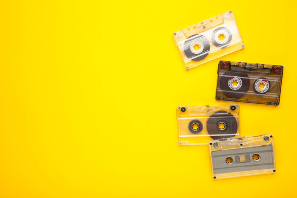 Inscription music day with old cassettes on a yellow background. Music day, top view - Fotoğraf, Görsel