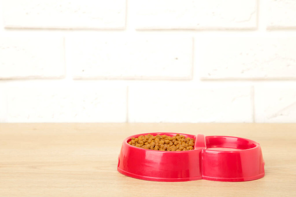 Red pet bowl on the light background. Top view - Foto, Bild
