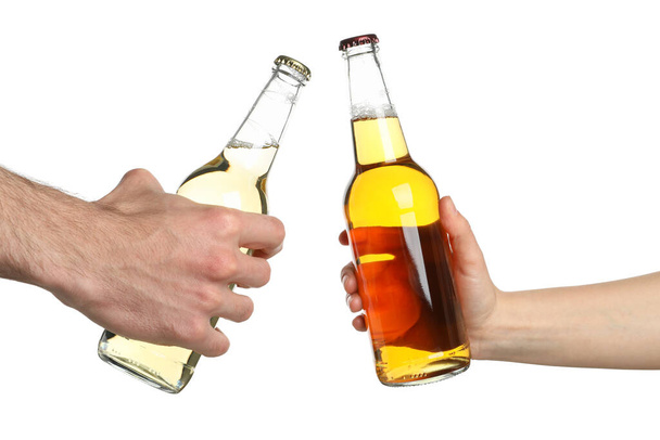 Hands hold bottles of cider, isolated on white background. Cheers - Fotografie, Obrázek