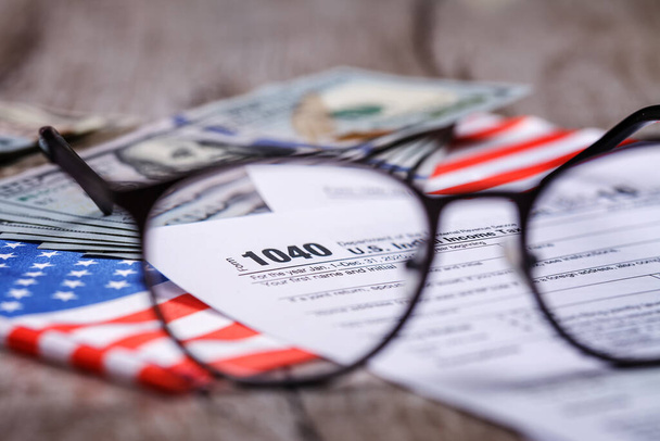 2020 tax return form 1040 with calculator and focus through glasses. The concept of filing a tax return, payment, return before April 2021 - Photo, Image