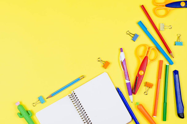 Colored different school supplies on soft yellow paper background. Notebook, pens, pencils and other tools. Back to school background. Flat lay, top view, copy space. Banner for site. - Photo, Image