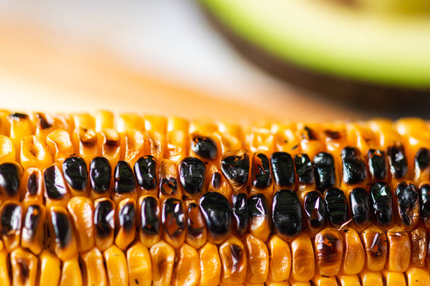 Barbecued corn on the cob. Yellow corn grilled until blackened. Summer food. Ear of corn - Photo, Image