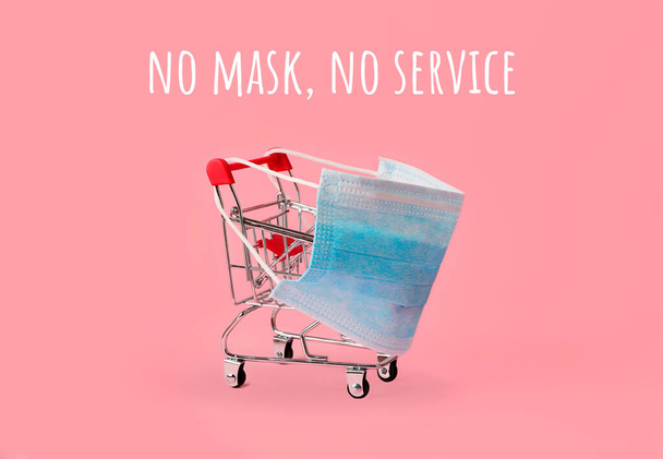 Shopping cart in blue medical mask.Concept of service during quarantine.Prevention from flu,coronavirus and other diseases. - Photo, Image
