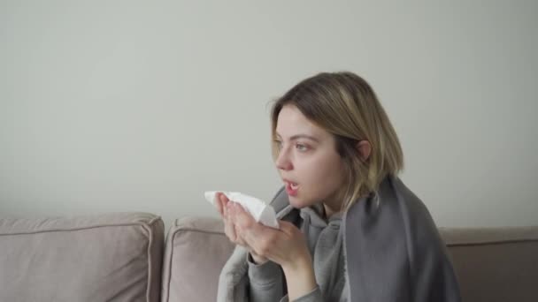A girl with tired eyes is sick and sneezes. Symptom of Orvi, coronovirus, acute respiratory disease, allergy, sinusitis. - Filmagem, Vídeo