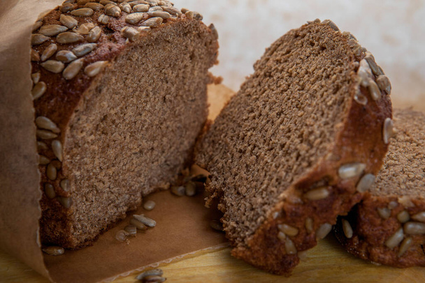 rye bread with sunflower seeds lies on the kitchen board - Photo, image