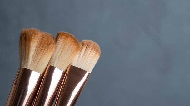 Professional makeup brush set on gray background. Various makeup brushes. Fashion background. - Photo, Image