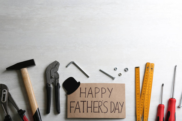 Card with words HAPPY FATHER'S DAY and tools on white background, flat lay. Space for text - Фото, зображення