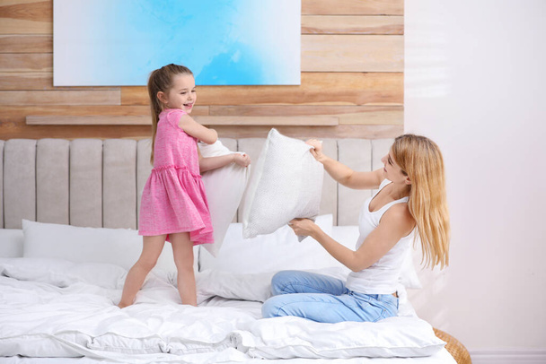 Mother playing with her child in bedroom at home - Foto, Imagem