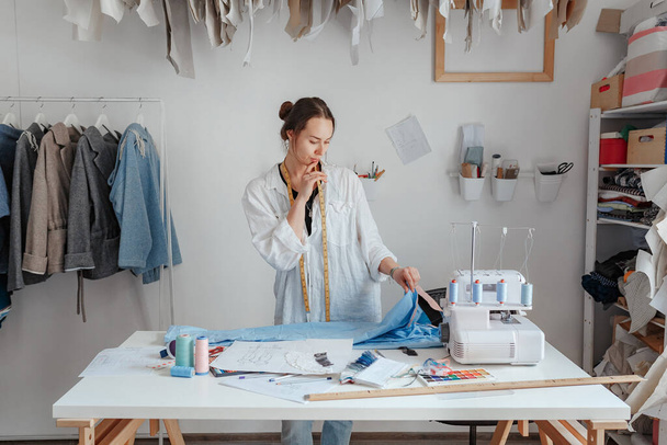 junge Kleidungsdesignerin in ihrem Atelier - Foto, Bild