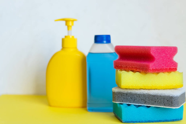 Household chemicals on white background. Professional cleaning products, spring cleaning.yellow and blue plastic containers for household detergents, home chemistry.cleaning supplies.Copy space - Foto, afbeelding