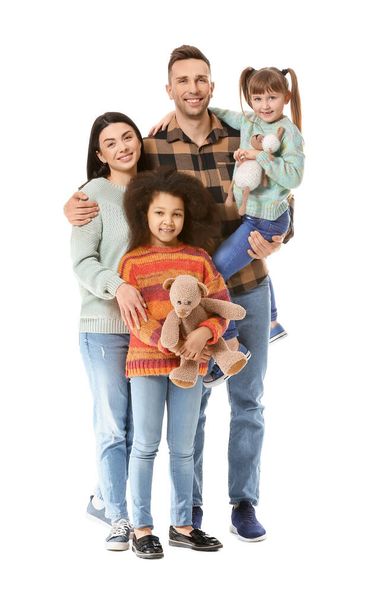 Happy couple with little adopted children on white background - Foto, immagini